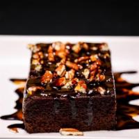 Turtle Brownie · Rich and decandant chocolate brownie topped with pecans pieces and chocolate and caramel dri...