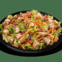 Crispy Chicken Salad · Our signature chicken strips, served hot and crispy, diced, and placed on a crispy blend of ...