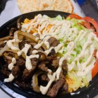 Lamb Shawarma platter · Marinated with special sauce. 
Served with rice and salad.