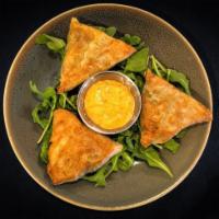Spanakopita · Crispy phyllo dough stuffed with spinach and feta served with Santa Fe sauce or Tzatziki.