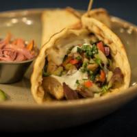 Grilled Chicken Pita · Grilled chicken thigh, mixed greens, summer salad and feta served in a warm flatbread drizzl...