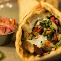 Chicken Shawarma Pita · Slow-roasted marinated chicken, mixed greens, summer salad and feta cheese wrapped in a warm...