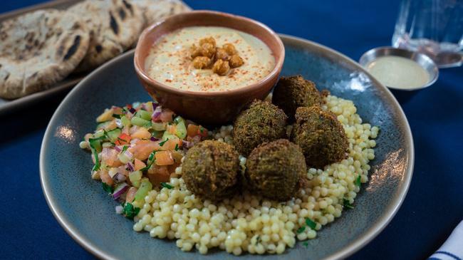 Falafel Platter · Five light and crispy falafel served over brown rice with a side of summer salad and your choice of a dip or spread. Served with warm pita and Tzatziki sauce. (V)
