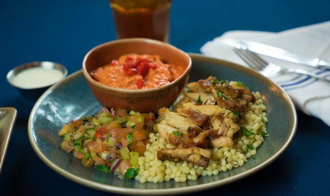Chicken Shawarma Platter · Slow-roasted and marinated chicken shawarma served over brown rice with a side of summer salad and your choice of a dip or spread. Served with warm pita and Santa Fe Sauce.