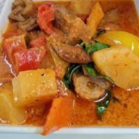Duck Curry  · Sliced roasted duck simmered with coconut milk, pineapple chunks, tomatoes, bell peppers and...