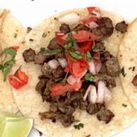 Tacos · Meat of choice, pico de gallo, and cilantro.