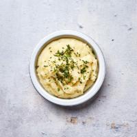 Parmesan Mashed Potatoes · Creamy and velvety Idaho mashed potatoes with freshly grated Parmesan cheese and chives.