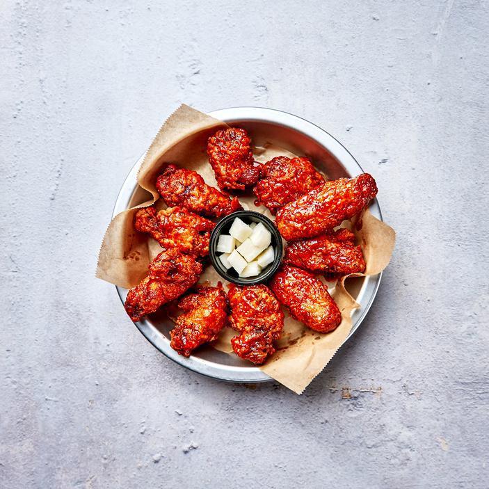 Korean Hot Spicy Wings · 10 pieces of Bell and Evans wings fried in our special olive oil blend and painted with our gochujang based glaze. UNAVAILABLE Served with pickled radish.