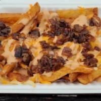 All American Fries · A mound of fries topped with house-made 1000 Island, grilled onions, and smothered in a ched...