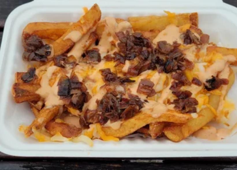 All American Fries · A mound of fries topped with house-made 1000 Island, grilled onions, and smothered in a cheddar Jack blend.