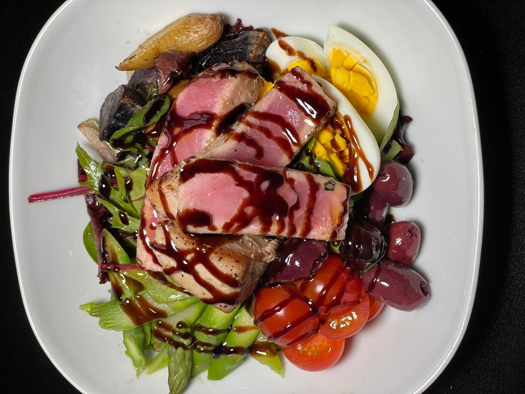 Tuna Nicoise · Roasted baby potatoes, grape tomatoes, boiled eggs, olives, and balsamic reduction.