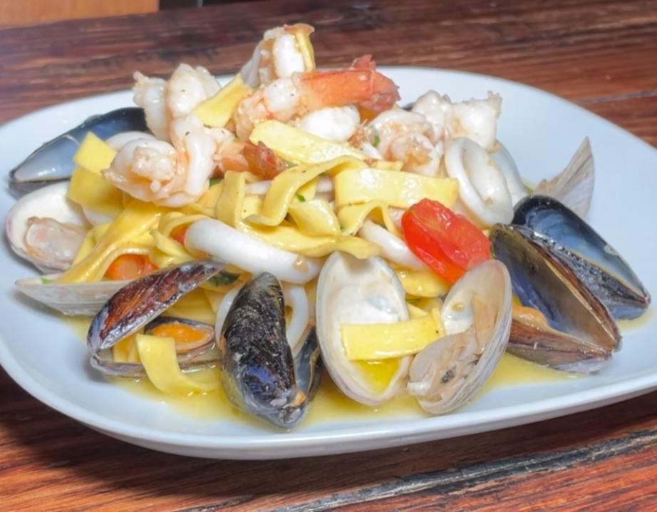Seafood Tagliolini · Baby clams, mussels, shrimp, calamari, grape tomatoes, white wine.