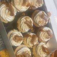 Ultimate Caramel Cupcakes · Salted caramel cupcakes serve with whipped cream frosting and caramel candy chews as topping.