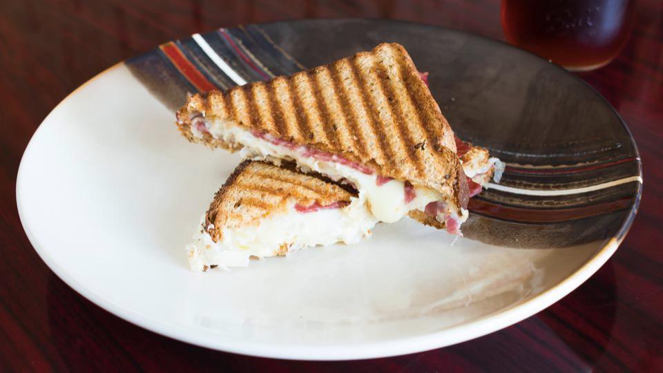 2. Reuben Sandwich · Corned beef, Swiss cheese, sauerkraut and 1000 Island sauce on whole grain bread. Served with chips.