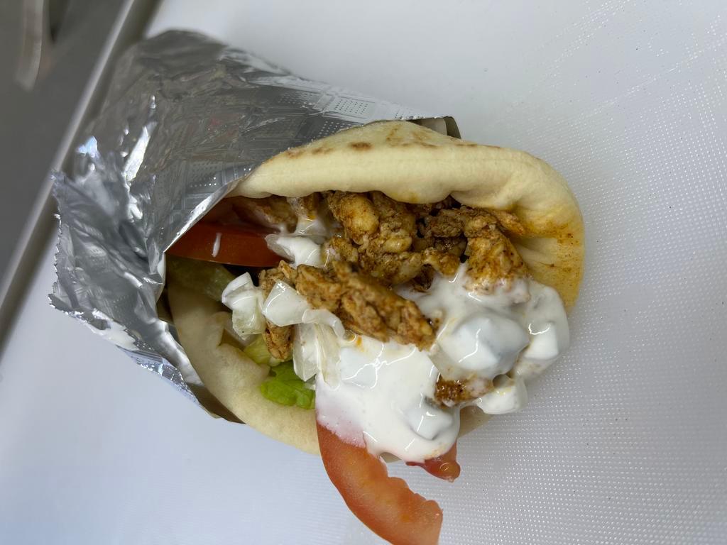 Chicken Gyro · chicken gyro, topped with lettuce, tomato, onion , tzatziki sauce and feta cheese on a pita bread.