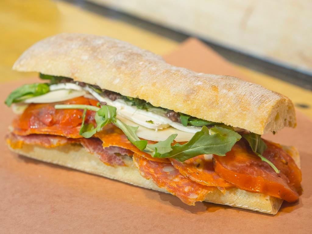 Hot Italian Sandwich · Hot Sopressata, hot capicola, pepperoni, roasted tomatoes, arugula, olive paste, pesto sauce, fresh mozzarella, provolone.
