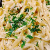 Fettuccine Alfredo · Served with your choice of mixed greens salad or Caesar salad.
