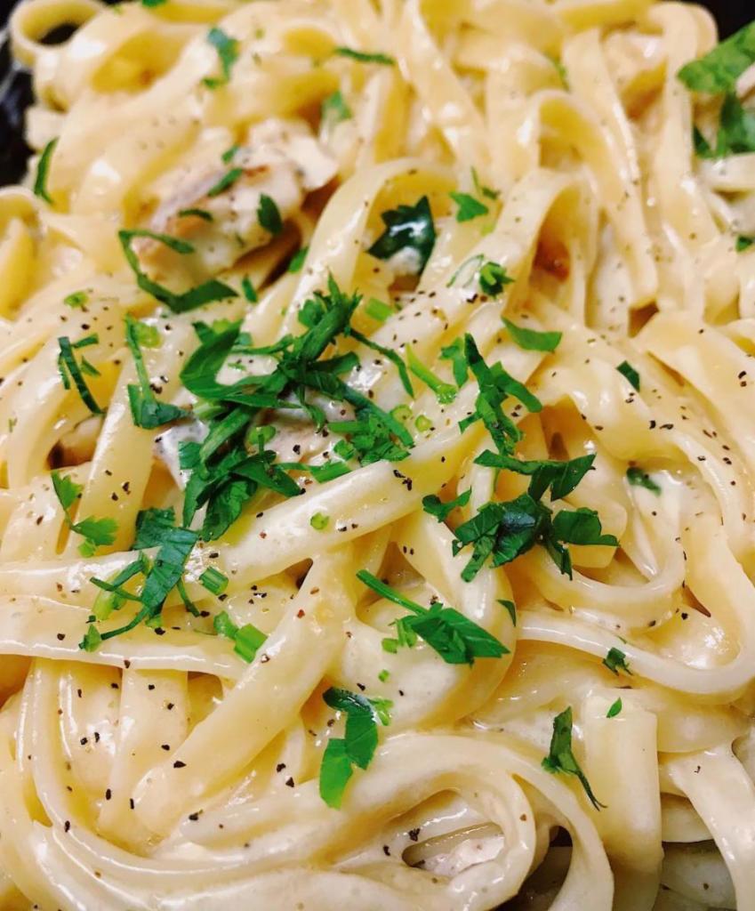 Fettuccine Alfredo · Served with your choice of mixed greens salad or Caesar salad.