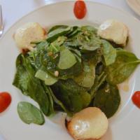 Goat Cheese and Spinach Salad · Warm Italian goat cheese, baby spinach, honey and roasted pine nuts.