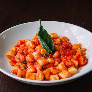Gnocchi di Mamma · Homemade gnocchi, fresh cherry tomato sauce, Parmigiano Reggiano and basil. Traditionally made like in Italy, al dente.