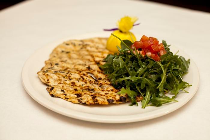 Chicken Breast Paillard · Organic grilled chicken breast served with arugula and tomatoes.