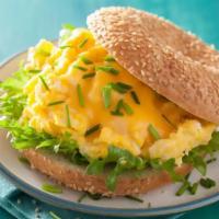 Bagel with Eggs · Fresh warm bagel with cooked eggs inside.