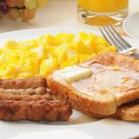 Sausage French Toast with Syrup · Fresh fluffy French toast topped with slices of sausage and syrup.
