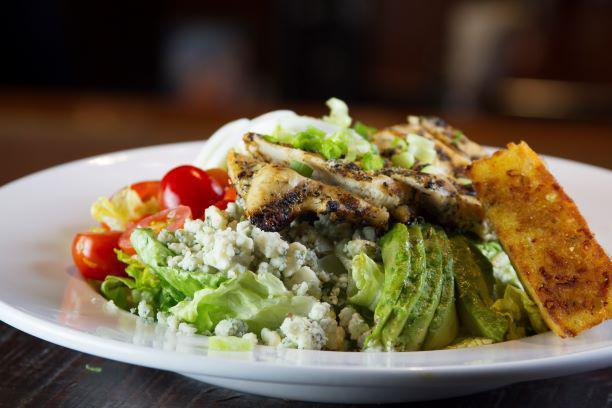 Cobb Salad · Mixed lettuce, grilled chicken, chopped bacon, blue cheese crumbles, green onions, avocado chunks, hard boiled egg, tomato, jalapeno cornbread.