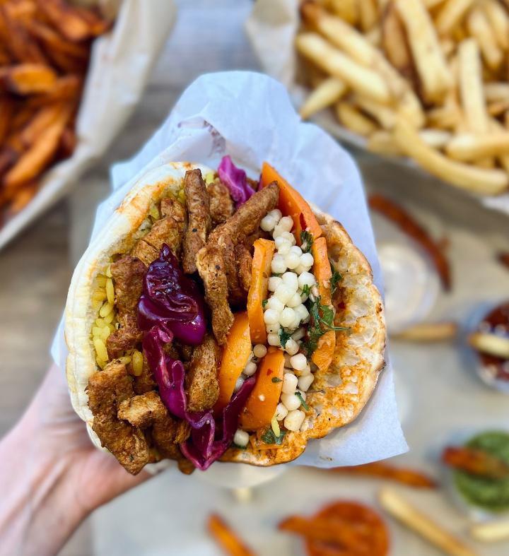 Vegan Pita Boxed Lunch · Includes Vegetable Based Shawarma Pita, (hummus, Israeli salad, red cabbage, lettuce, and tahini) a side of ( French Fries, Boureka, or Dessert), and a Can Of Soda or Bottle of Water.