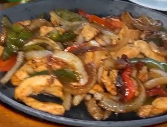 Classic Fajitas · Served on a hot sizzling cast iron skillet with peppers and onions. Served with flour soft tortillas, pico de gallo, sour cream, and guacamole.