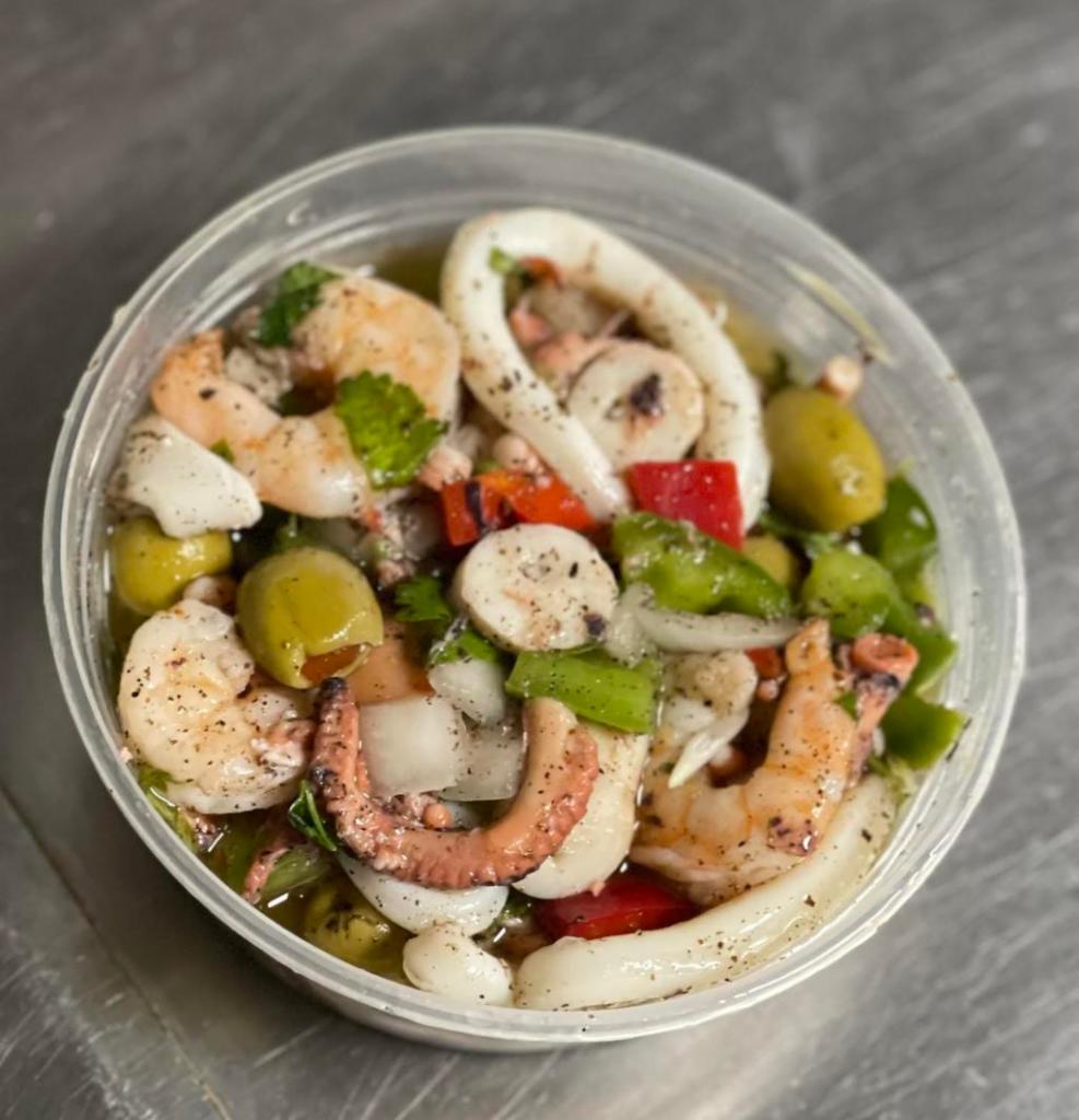 Seafood Salad · Octopus,Shrimp,Calamaris, Green Peppers, Red Peppers, White Onions, Olives in a Fresh Lime Juice and Olive Oil Marinade.