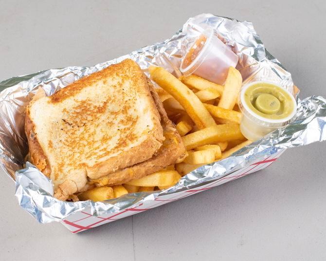 Return of Mac · Grilled cheese with green Chile mac and cheese in the sandwich with fries or mac.
