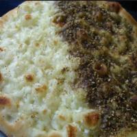 Mix Zaater and Cheese · fresh baked flat bread crust, Cheese, Zaater (thyme) 