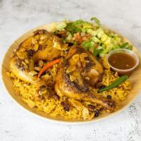 Mandi Chicken over Rice · chicken marinated with homemade special spices served with rice, salad, and daqus hot sauce