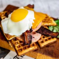 The Bruiser Waffle · Triple decker waffle sandwich - bacon, cheddar, Canadian bacon, egg.
