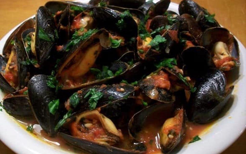 Mussels Fra Diavolo · Mussels served in aspicy marinara sauce.