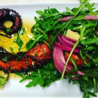 Spanish Octopus · Cooked sous vide, then pan-seared, and served with a Mediterranean  , salad of arugula, arti...