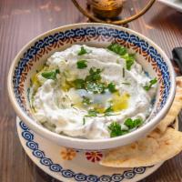 Yogurt Dip with Pita Bread · Fresh yogurt with mint and various varieties of spices topped with olive oil.