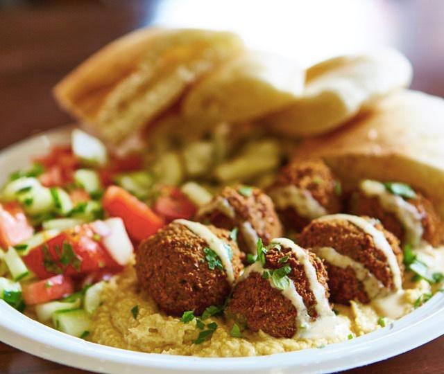 Falafel Plate · Served with hummus, tahini, Israeli salad, pickles, and pita.