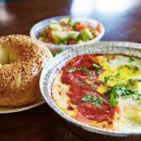 Shakshuka · 2 eggs sunny side in special tomato sauce with bread and Israeli salad.