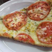 Pesto and Tomato Pizza · Ricotta pesto and plum tomato.