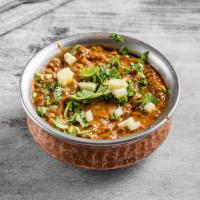 101. Dal Makhani · Black beans cooked with butter and Indian spices.