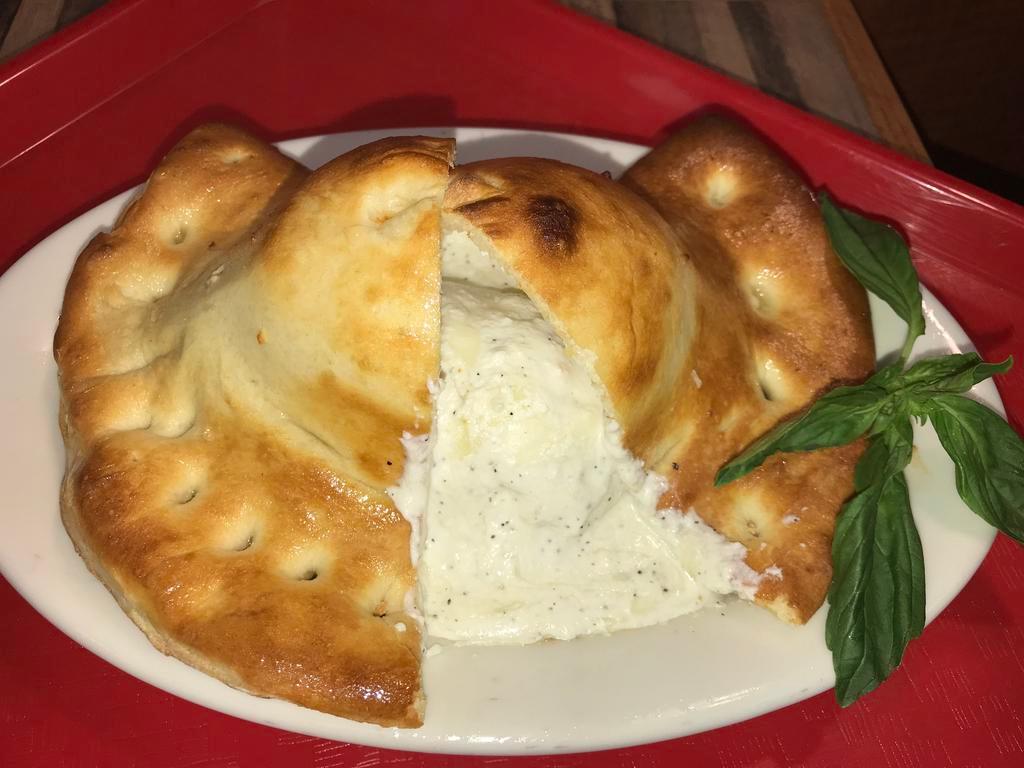 Calzone · Pizza dough packets filled with whole milk ricotta and mozzarella cheese. Add toppings for an additional charge.