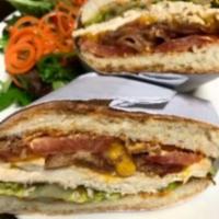 ROASTED TURKEY PANINI · Served with sharp cheddar cheese, double smoked bacon, sliced tomato, green leaf, and chipot...