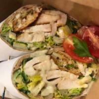 GRILLED CHICKEN CAESAR SALAD WRAP · House made  tender grilled chicken breast, romaine lettuce, Parmesan cheese  and Caesar dres...