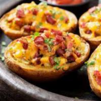 Potato Skins  · Potato skins topped with cheese ,bacon and chives and sour cream 