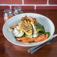 Chicken Cobb Salad · Grilled chicken, field greens, avocado, bacon, tomatoes, hard-boiled eggs, and blue cheese.