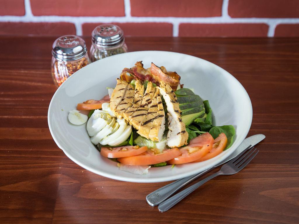 Chicken Cobb Salad · Grilled chicken, field greens, avocado, bacon, tomatoes, hard-boiled eggs, and blue cheese.