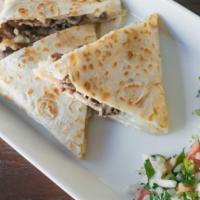 Quesadilla Suisa with Meat · Cooked tortilla that is filled with cheese and folded in half. 