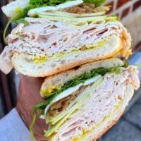 The Michelle · Turkey, Brie, Sliced Apple, Caramelized Onions, Arugula, Honey Mustard.
Served on a Lightly ...